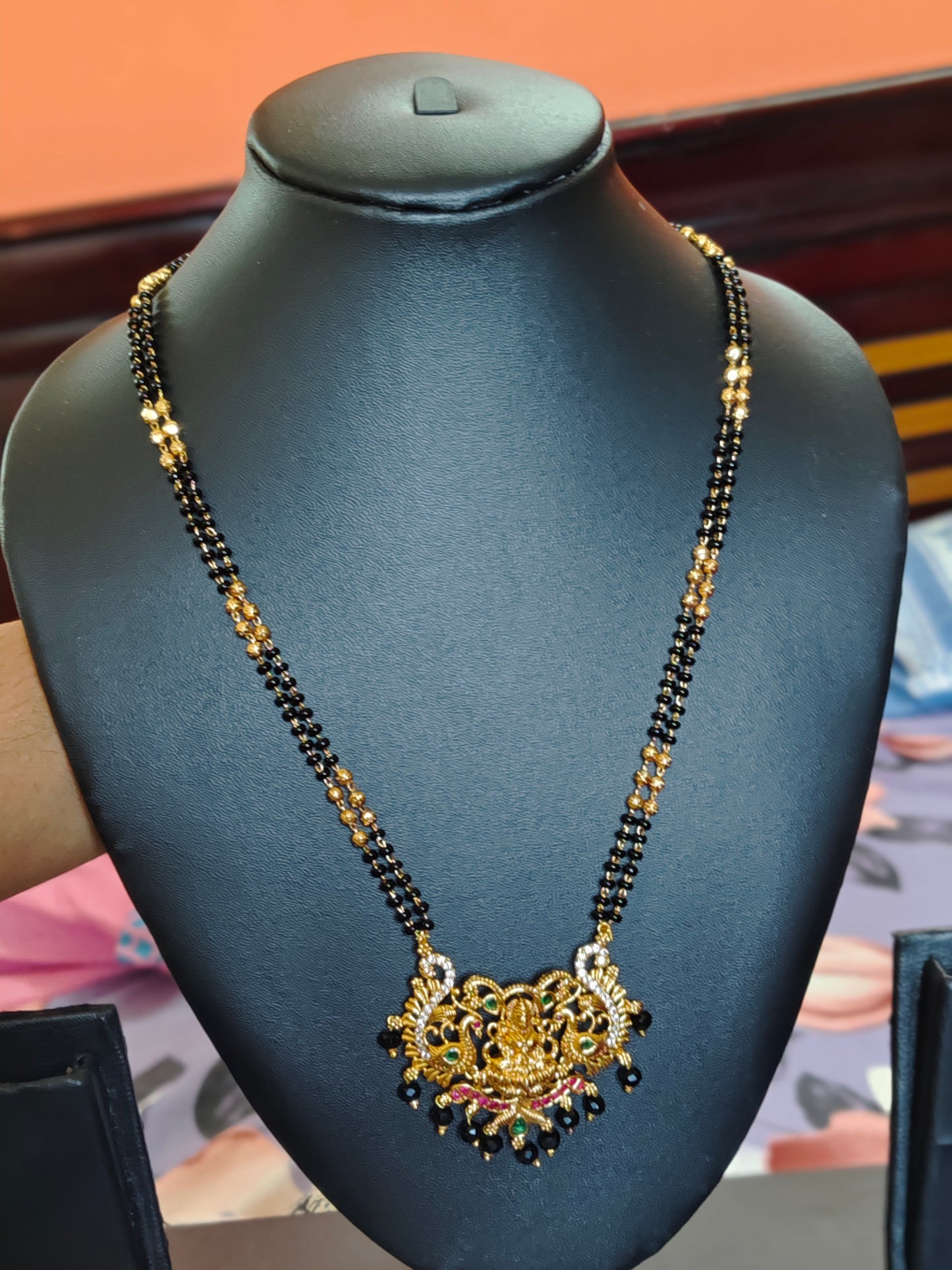 LONG BLACK BEADS CHAIN WITH LAKSHMI DEVI IN THE CENTRE PEACOCKS ON BOTH SIDES