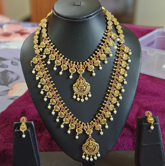 GORGEOUS BRIDAL SET WITH LAKSHMI DEVI MOTIFS AND DROPPING PEARLS