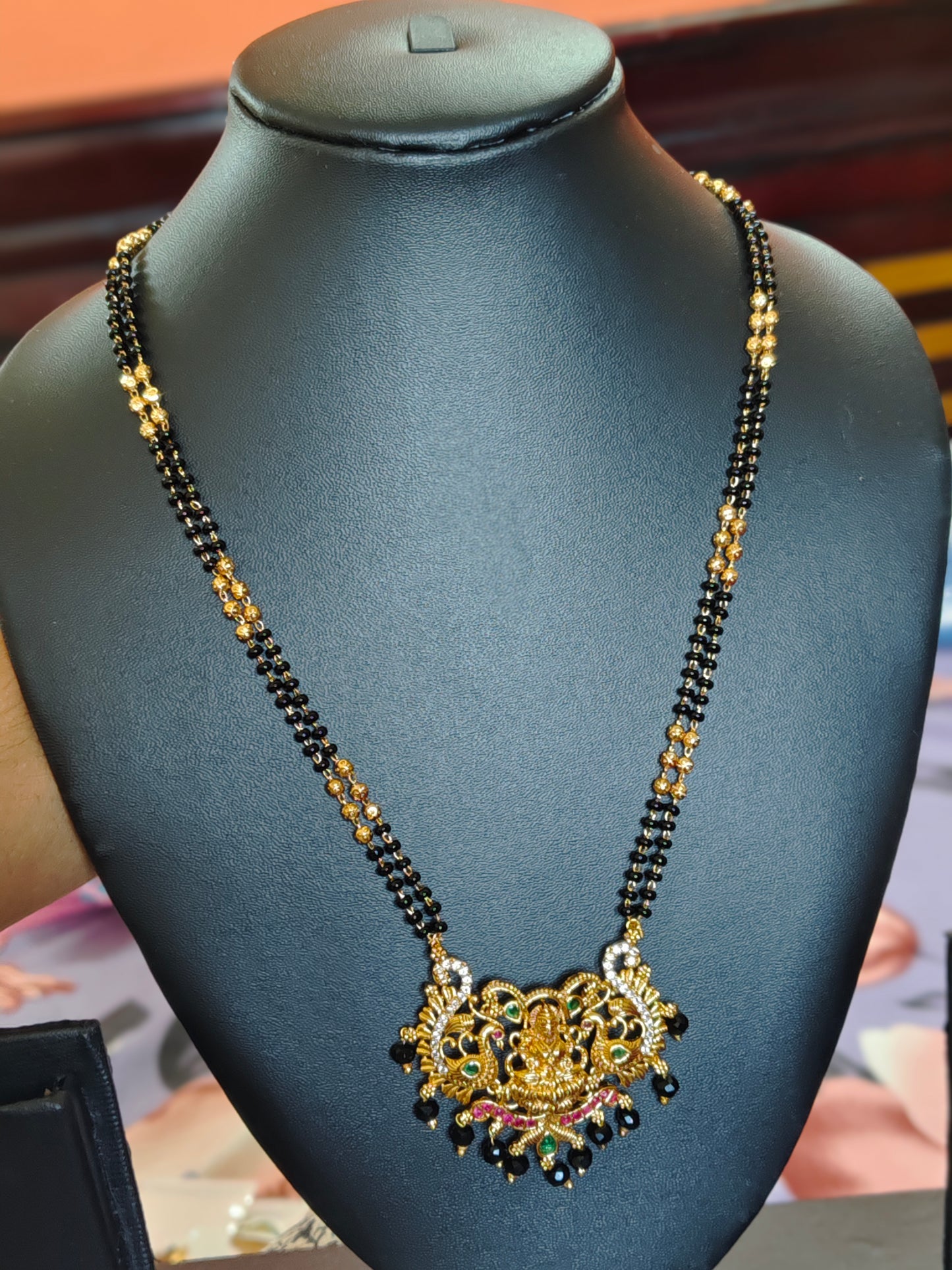LONG BLACK BEADS CHAIN WITH LAKSHMI DEVI IN THE CENTRE PEACOCKS ON BOTH SIDES
