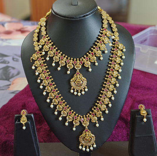 GORGEOUS BRIDAL SET WITH LAKSHMI DEVI MOTIFS AND DROPPING PEARLS